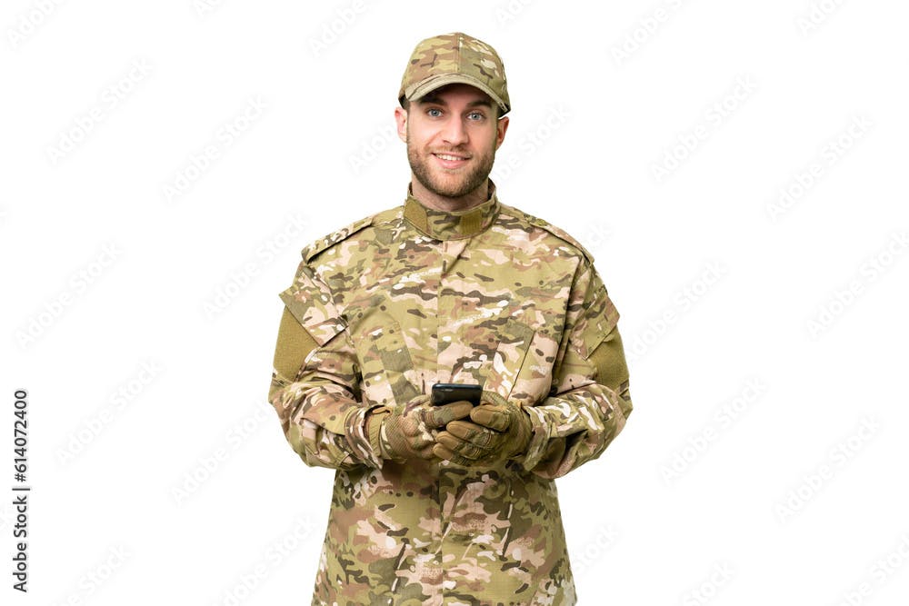 Military man over isolated chroma key background sending a message with the mobile