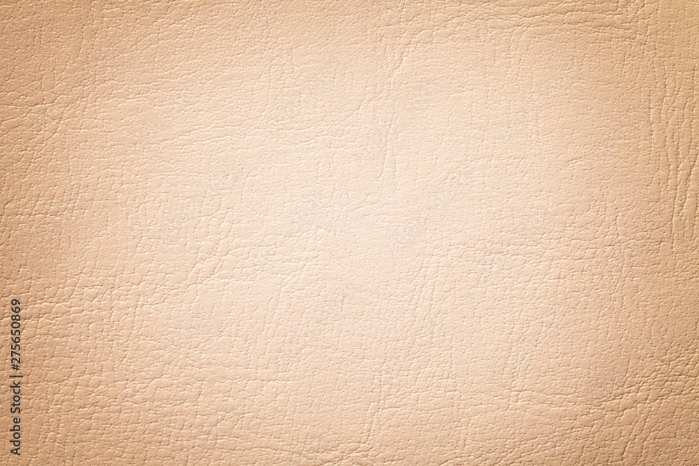 Light coral leather texture background, closeup. Beige cracked backdrop