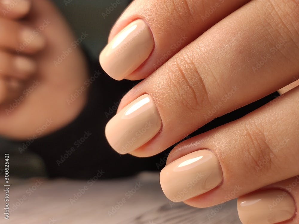 Hands Care. Hand With Pastel Nails In Sea Salt. Close Up Of Woman Hand With White Manicure In Pink Sea Salt.