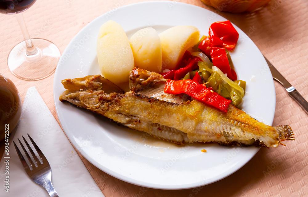 Roasted ballan wrasse (maragota) served with marinated vegetables and potato - Spanish fish dish