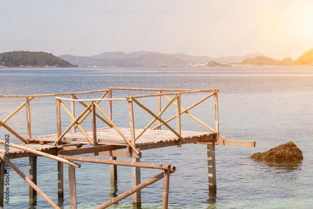 Tropical beach in Kham island, Chonburi, Thailand with light flare effect