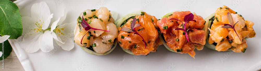 Rainbow Sushi Roll with salmon, tuna, avocado, royal prawn, cream cheese Philadelphia, caviar tobica, chuka. Sushi menu. Japanese food