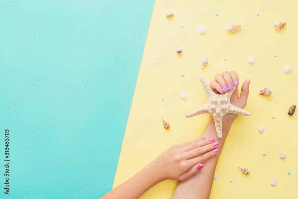 Bright manicure on yellow and mint backgrounds.