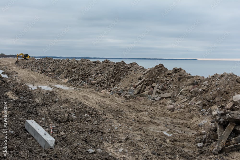 Construction debris - concrete blocks and stones dumped on seashore