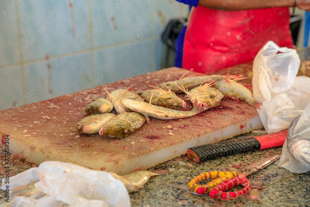 Details of pearly goatfish on wooden cutting board at Al Khor Fish Market in Qatar, Middle East, Arabian Peninsula.